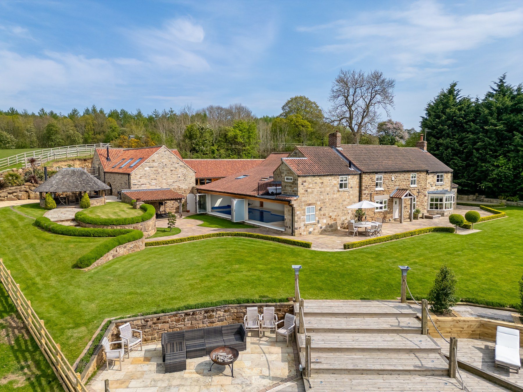Osgoodby Cottage, its pool wing, summer house and terraces seen from above